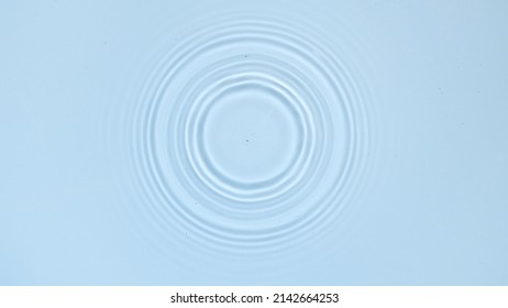 Circles on water surface on pale blue background | Background shot for skin care cosmetics commercial