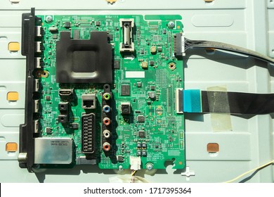 Circuit board for green LCD TVs integrated in the TV panel. Circuit board close-up, top view with many different types of chips and resistors. Used as an illustration. - Shutterstock ID 1717395364