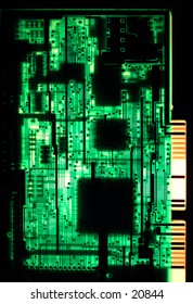 A circuit board from a late 1980s 286 computer, viewed from  behind and backlit.