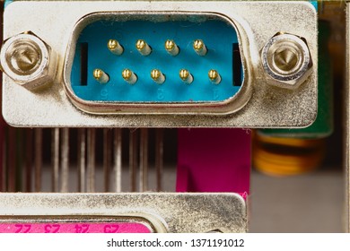 Circuit Component.  This Is A Macro View Of A Serial Communication Port On A Circuit Board.  This Image Depicts “old” Technology But Could Also Be Considered Abstract.