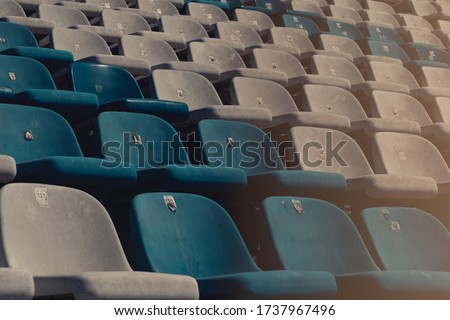 Circuit seats without spectators. Empty stadium without fans. Concept of sports show held behind closed doors. Consequences of the COVID-19 pandemic. Security measures in different sports.