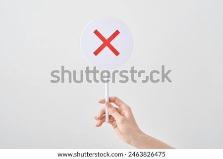 Circular answer sheet with a cross written on it