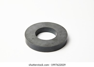 Circular black ferrite ring magnet isolated on a white background