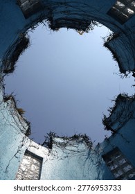Circular Blue Structure With Open Sky View