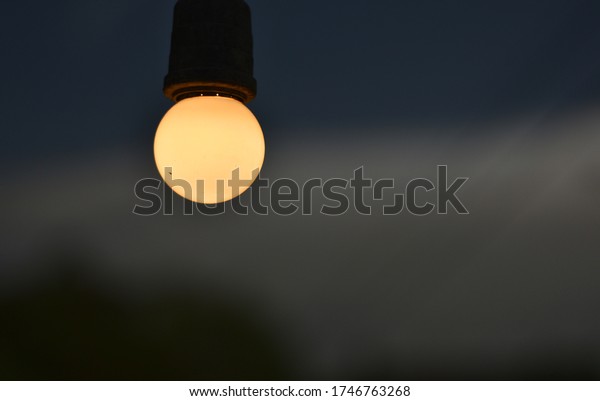 Circular bulb\
shining background overcast\
sky