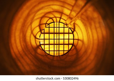 Circular and criss cross geometric pattern moves from yellow to orange to black