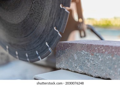 The circular diamond saw cuts concrete paving slabs. Concrete cutting machine close-up