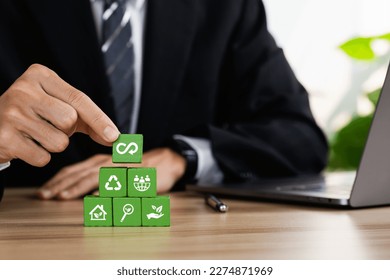 Circular economy concept. Business and environment sustainable. Climate changing problem solving goals. Stacking wooden cubes with sustainability icon on pollution sources icon with grey background.