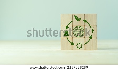 Circular economy concept, recycle, environment, reuse, manufacturing, waste, consumer, resources. LCA Life cycle assessment. Sustainability Wooden cubes; symbol of circular economy on grey background.