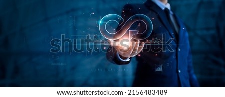 Circular economy and infinite. Businessman holding circular infinity colorful symbol on dark blue, Strategy of investment, Banking and financial, Development and data exchange for business growth.