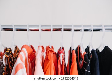 Circular Economy, Second Hand, Fast Fashion, Sustainable Fashion. Many Second Hand Red Colors Clothes Hanged On Clothes Rack.