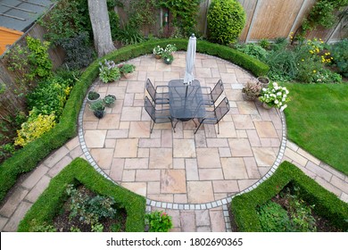 circular garden patio with freshly jet washed paving stones - Shutterstock ID 1802690365