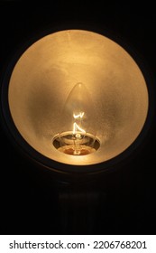 Circular Lamp With A Yellow Light Bulb Turned On