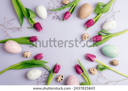 Circular layout with Easter eggs, tulip flowers on pastel lilac background. Top view, flat lay, copy space.
