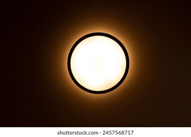 circular light on the ceiling in a dark room