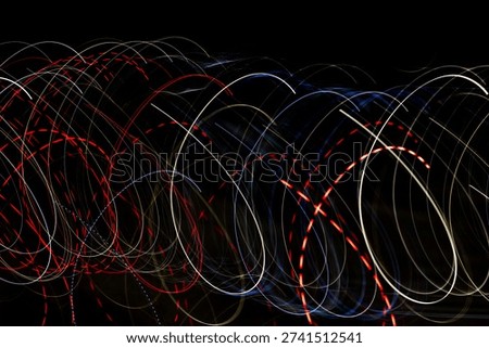 Circular light trails at night create neon loops and dotted bokeh suggesting data flow and dj lightshow highcontrast