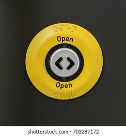 Circular Metal Button With Arrows On It To Open A Door, Shot Straight On.