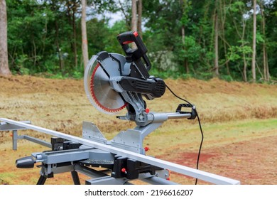 Circular miter saw on saw stand with under construction a newly constructed house