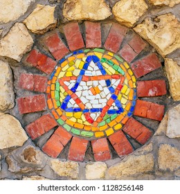 Circular Mosaic Religious Symbol Star Of David On Stone Wall.