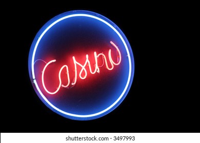 A Circular Neon Sign At A Casino