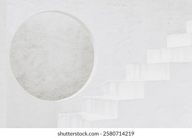 A circular opening in a white wall frames a simple, curved staircase. The composition creates a sense of balance and elegance, focusing on symmetry and modern architectural style.