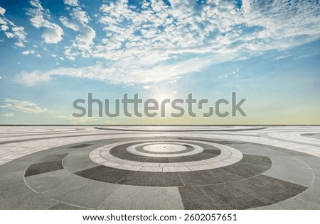 Circular pattern floor with sun and blue sky in background