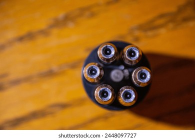 The circular pattern made by six bullets in a speed loader for a revolver.