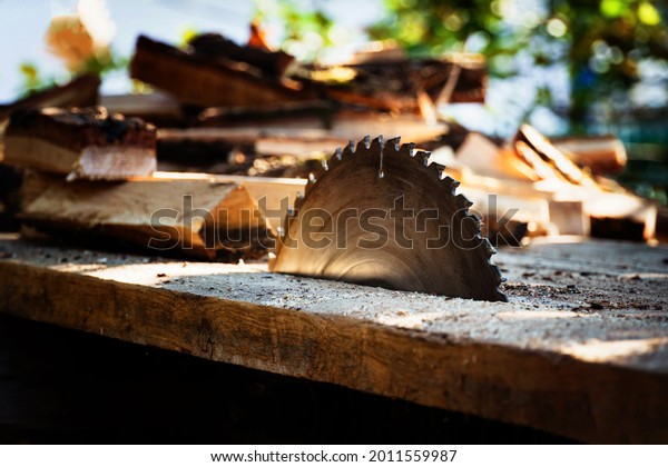 circular power saw for cutting wood. circular\
saw blade on a wooden\
machine.