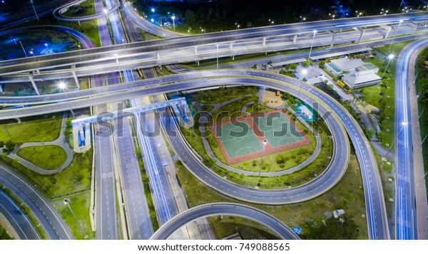Circular road. Aerial\
view at junctions of city highway. Circle Road. Road beautiful\
Aerial View of Busy Intersection at Night , top view , thailand\
.Vehicles drive on\
roads.