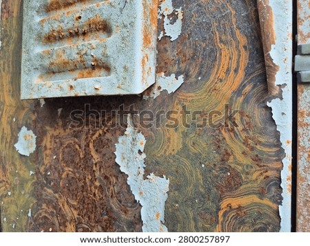 circular rust pattern on an iron plate featuring air vents