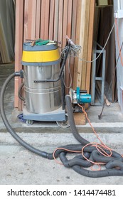 Circular Saw With Big Industrial Vacuum Cleaner In Wood Work Shop