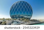 Circular skyscraper Aldar Headquarters Building timelapse hyperlapse in Abu Dhabi, UAE. View from bridge. It is the first circular building of its kind in the Middle East.