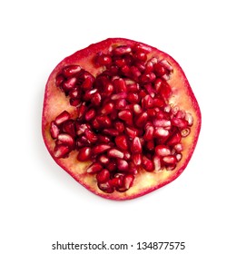 Circular Slice Of Pomegranate Full Of Seeds, Isolated On White Background.  Overhead View.