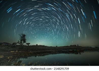 Circular star trails over the lake. Astro photography and Nightscape photography at Mandan Lake, Rajpipla, Gujarat - Shutterstock ID 2148291709