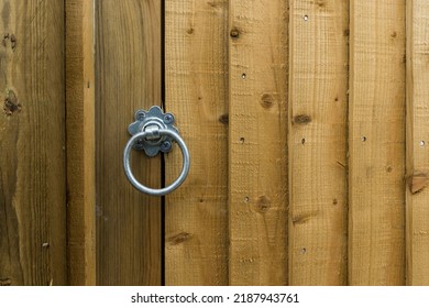 Circular steel latch in a newly installed rough timber garden gate - Shutterstock ID 2187943761