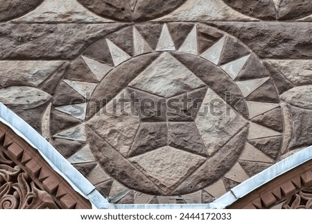 Circular stone decoration. Colonial architectural feature or detail in Old City Hall Building (1898), Toronto, Canada