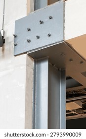 The circular structural steel frame supporting the bridge walkway is made of I-beams, connected with large bolts.