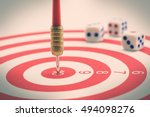 Circular target, red dart and dices. An idea of targets i.e business, price, audience, market, group, practice, analysis, risk, range, rate, state, tracking, area, value, cost, site, etc.