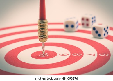 Circular target, red dart and dices. An idea of targets i.e business, price, audience, market, group, practice, analysis, risk, range, rate, state, tracking, area, value, cost, site, etc. - Shutterstock ID 494098276