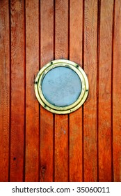 Circular Window On A Timber Door Of A Boat