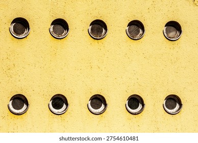 Circular window pattern on communist era building facade, socialist architecture design