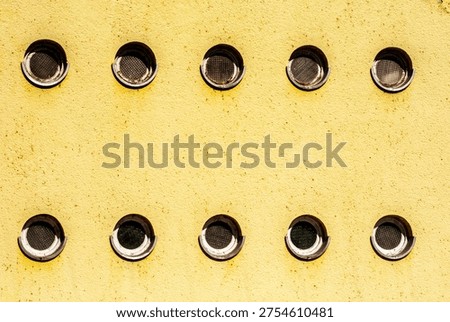 Circular window pattern on communist era building facade, socialist architecture design