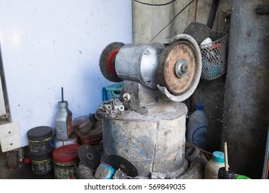 Circular wire grinding brush machine. Steel polisher in garage.