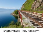 Circum-Baikal Railway. Rails on the shore of Lake Baikal. Railroad bridge.