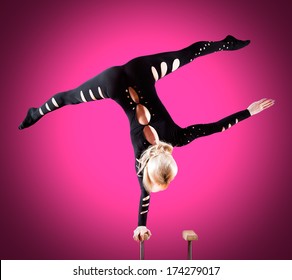 circus actor standing on the hand on a blue background - Shutterstock ID 174279017