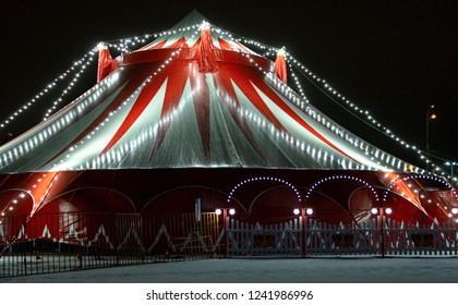 The circus illuminated and decorated with garlands of light bulbs, at night