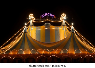 Circus tent at night with its colorful lights on