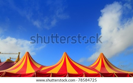 Circus tent red orange and yellow stripped pattern blue sky