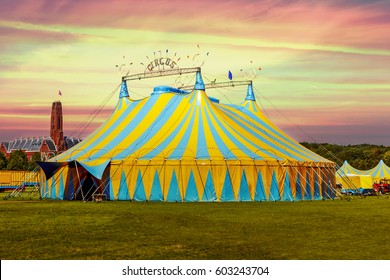 Circus tent under a warn sunset and chaotic sky without the name of the circus company which is cloned out and replaced by the metallic structure - Shutterstock ID 603243704