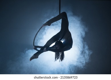 Circus Woman On Aerial Hoop In Blue Light